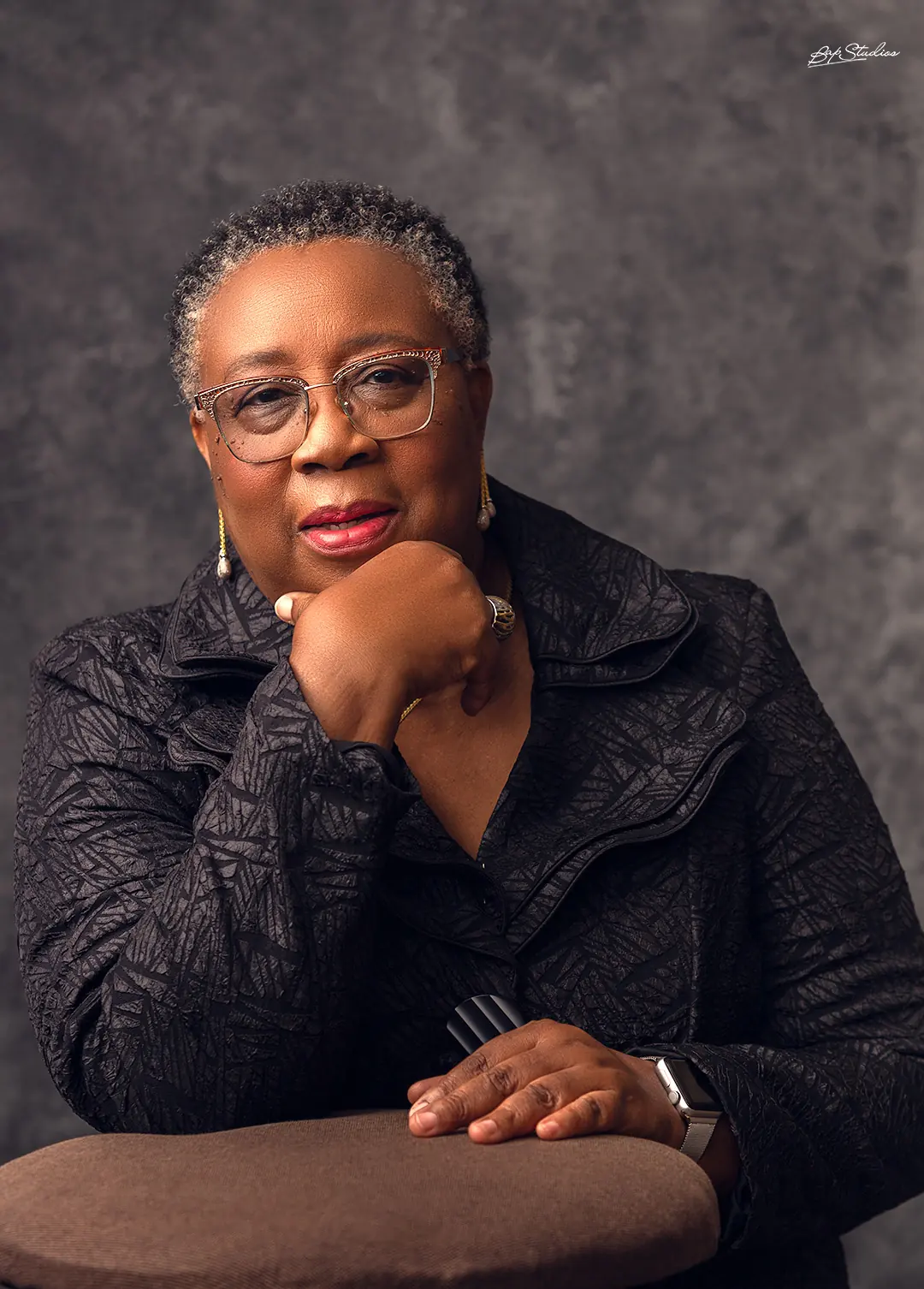 Folasade Adefisayo resting her chin on her hand, looking directly to camera.